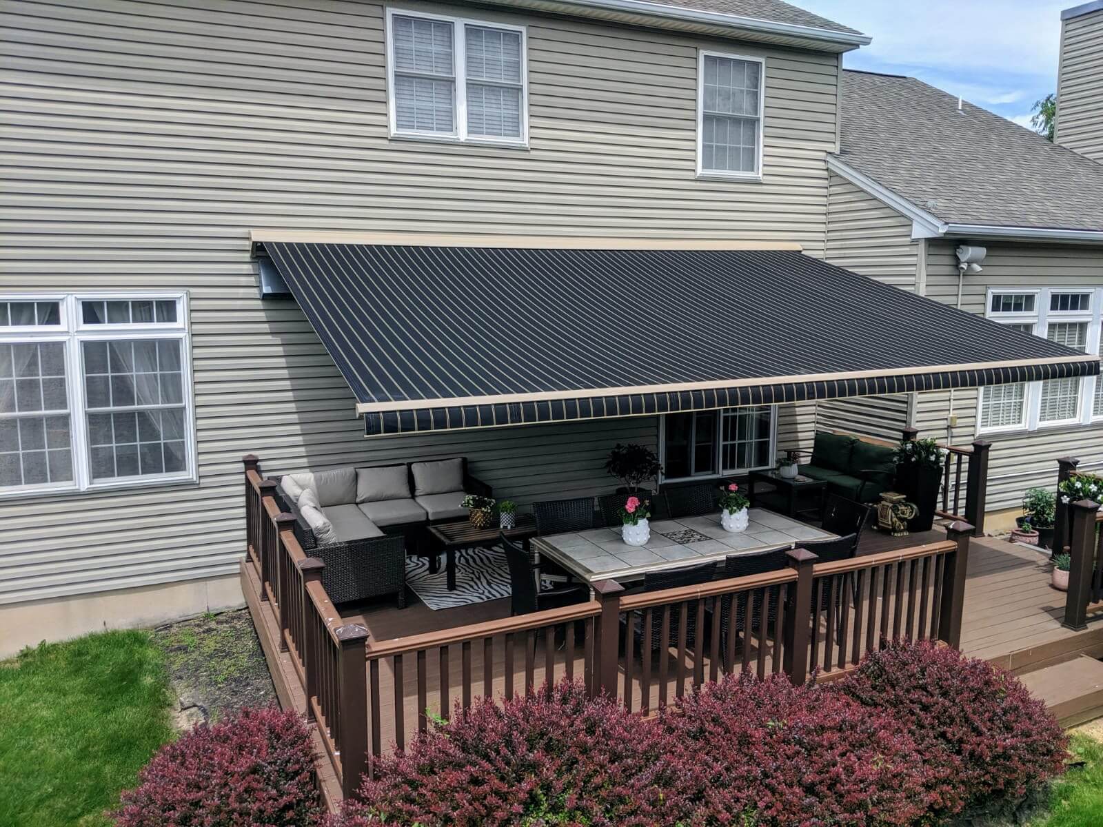 Furnished deck with large black awning