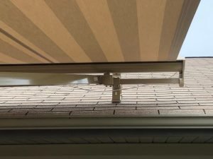 Close up of a retractable awning attached to a roof